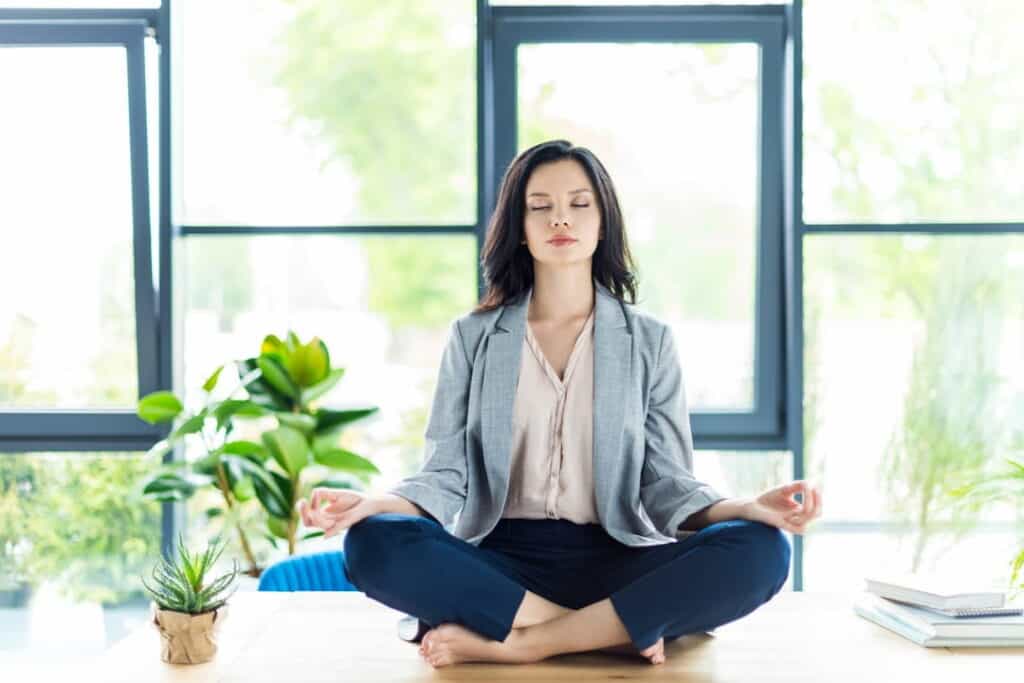 a woman meditating in the room