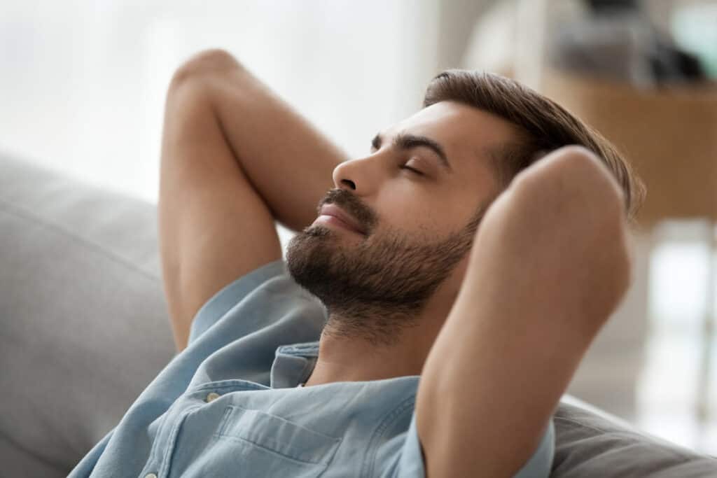 a young man relaxing with his eyes closed