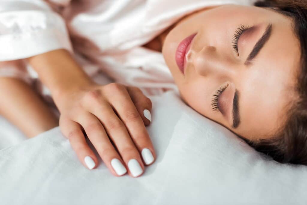 beautiful young woman sleeping on a pillow