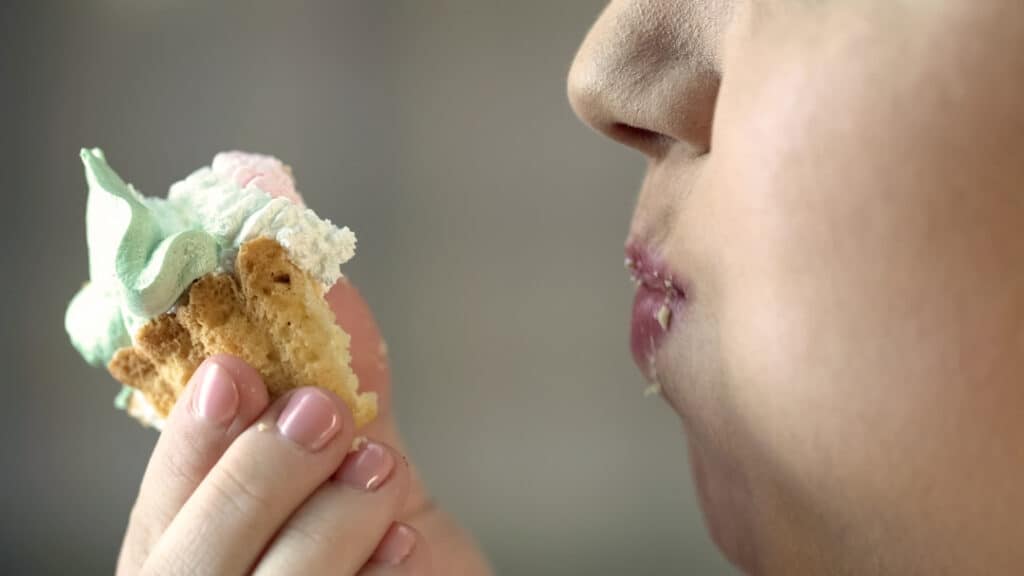 closeup of a person eating cupcake