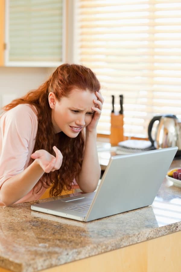 a woman trying to solve the problem with her laptop