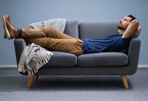 a man lying down on the sofa