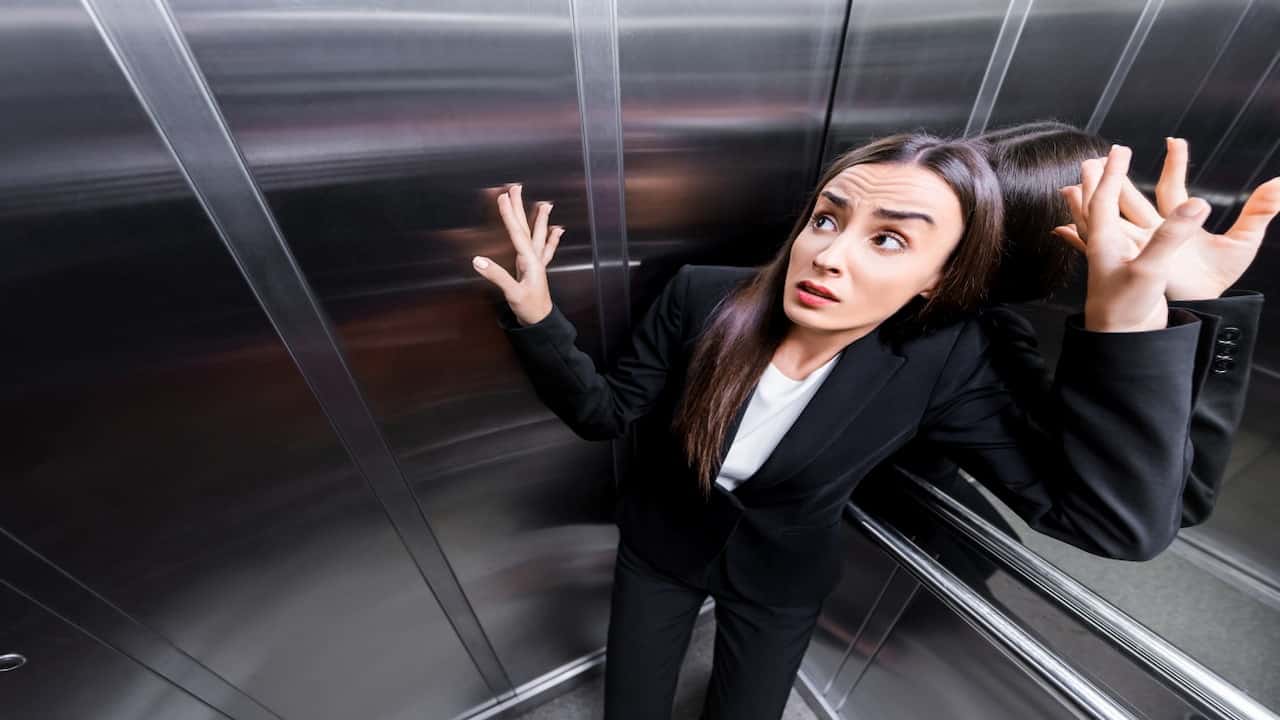 a scared woman in the elevator
