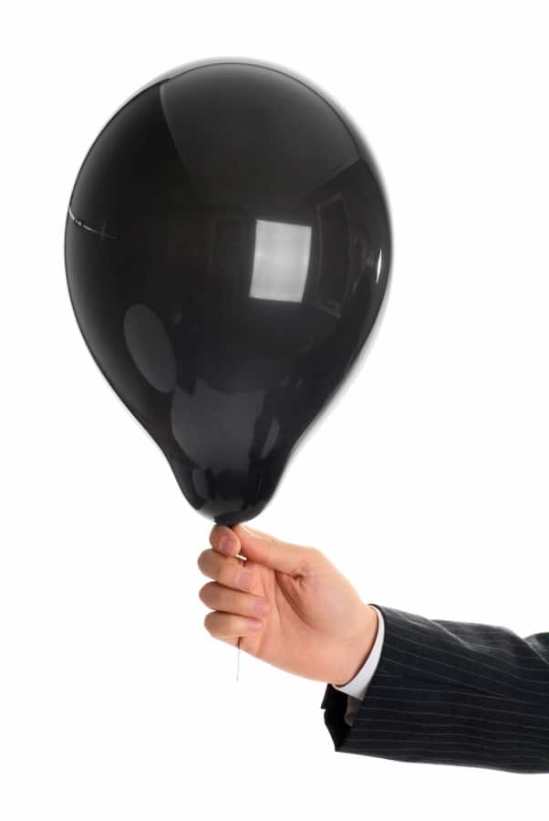 a hand holding the black baloon