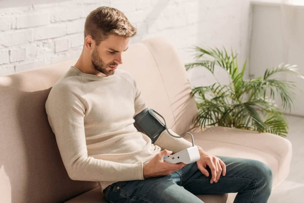 a young man measuring his blood pressure