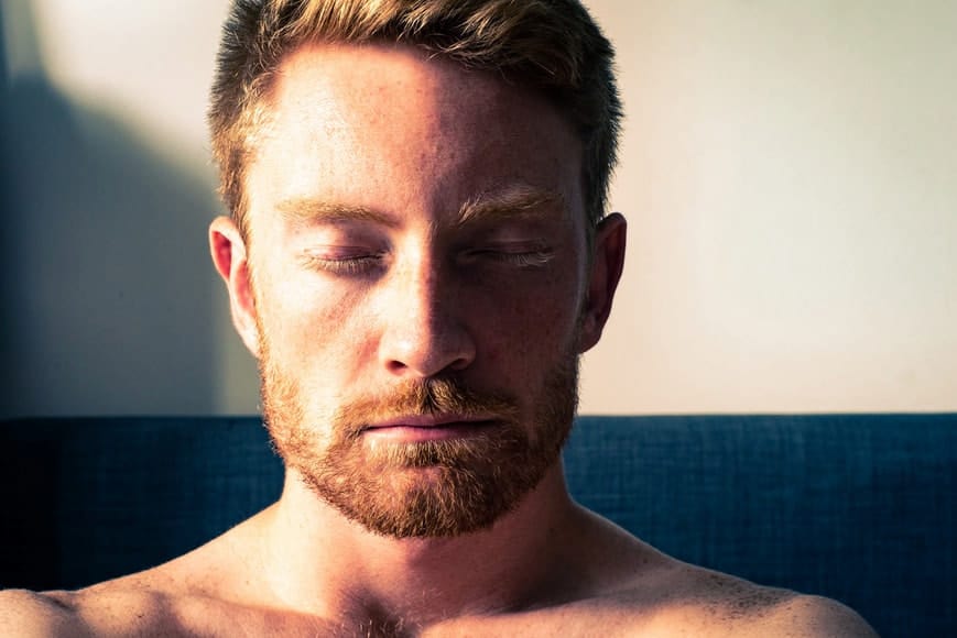 a portrait of a red hair and beard man with close eyes