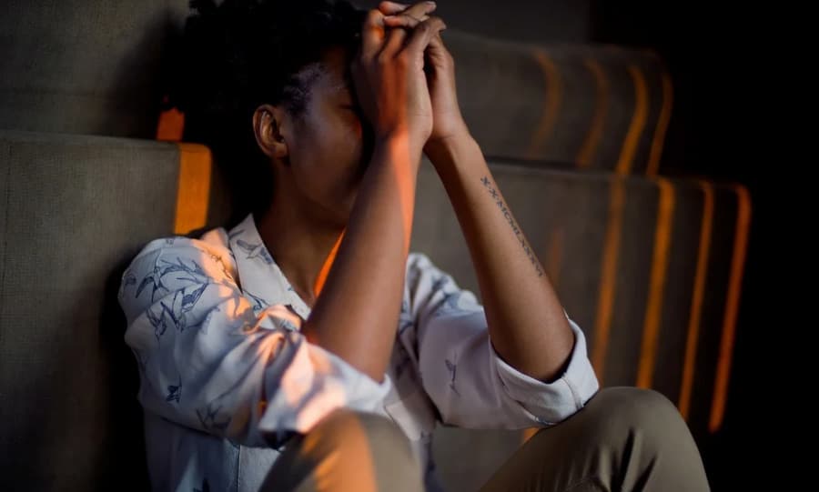 a stressed person sitting in the dark room