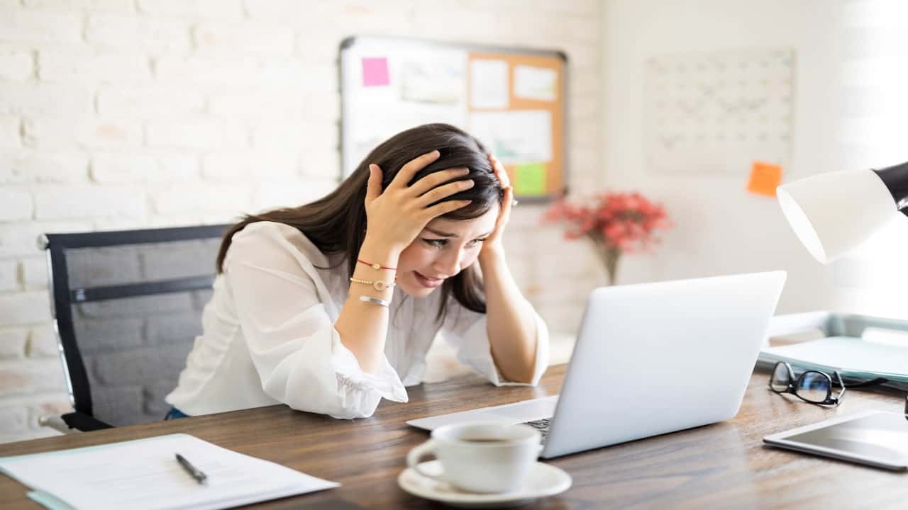 a frustrated woman in front of the laptop