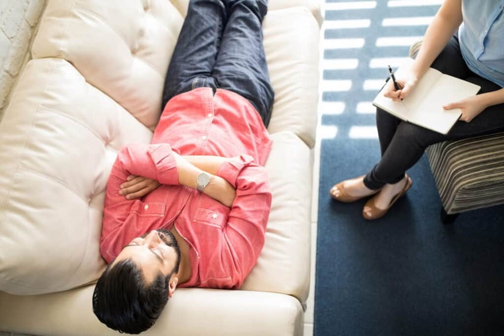 a patient lying on the couch during the hypnosis session