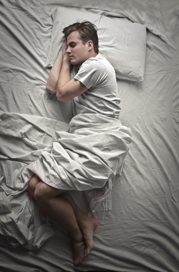 a man sleeping in the bed