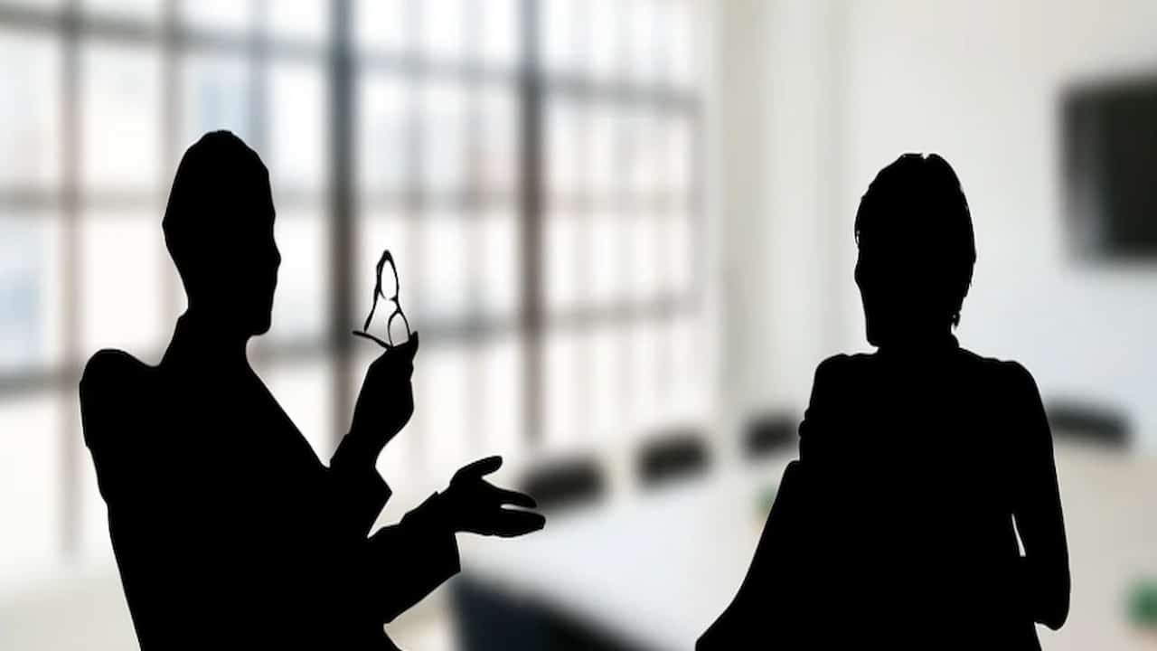 silhouettes of two person talking