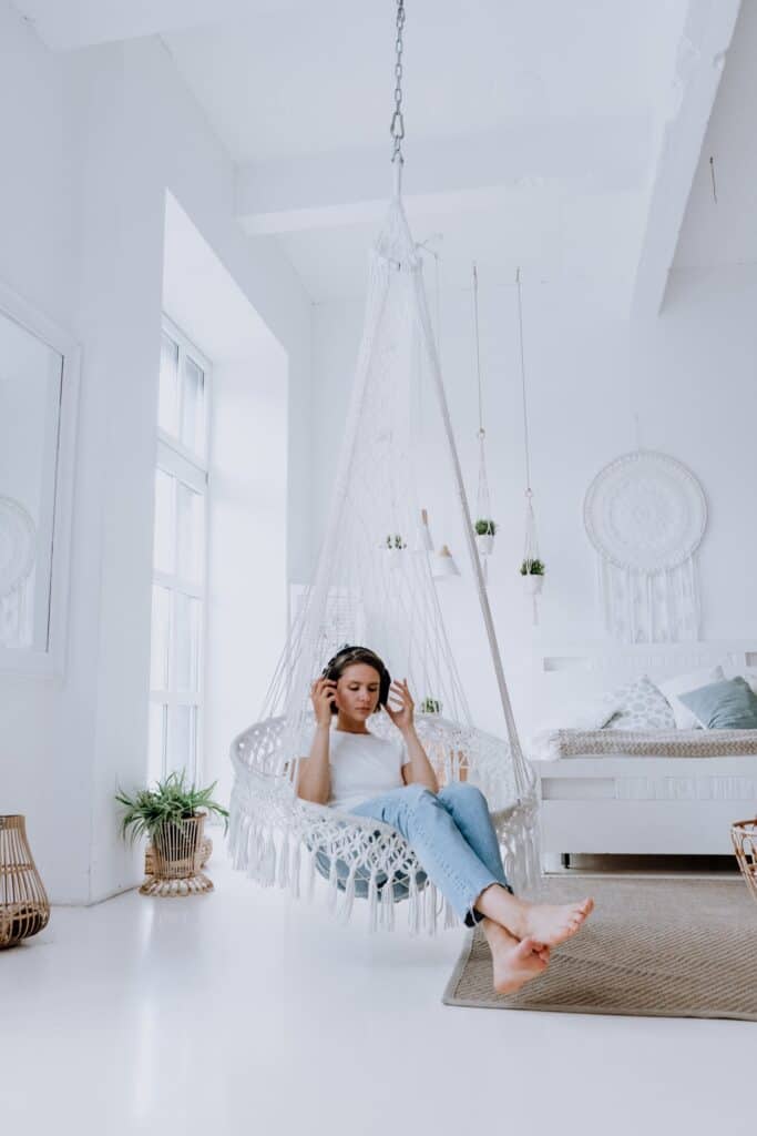 a woman listening to downloads in her bedroom