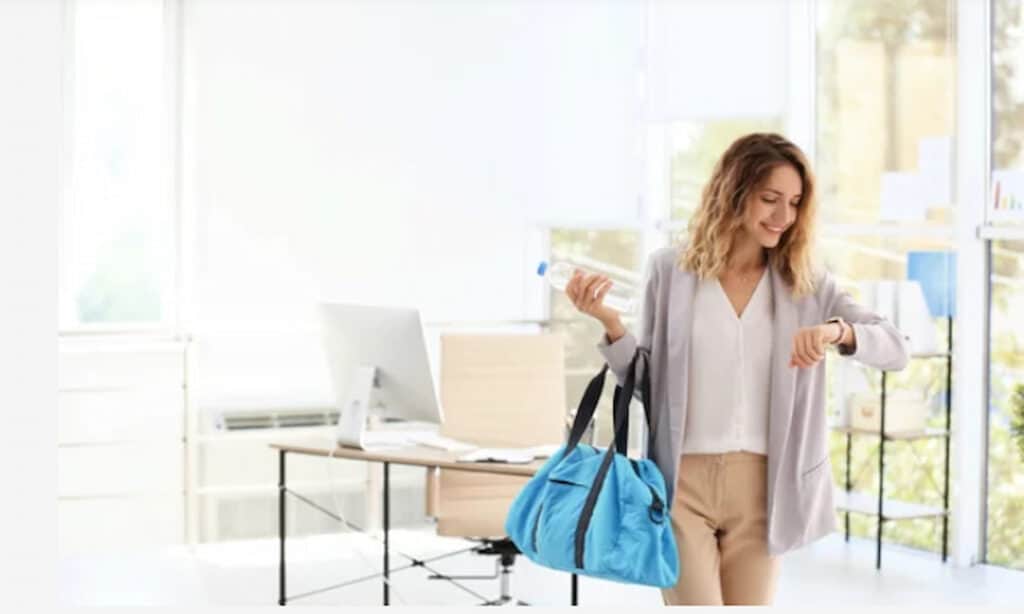 a smiling woman leaving the office