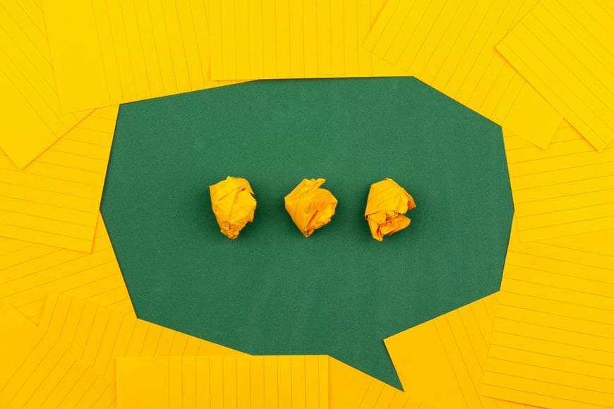 speaking symbol made of green and yellow paper